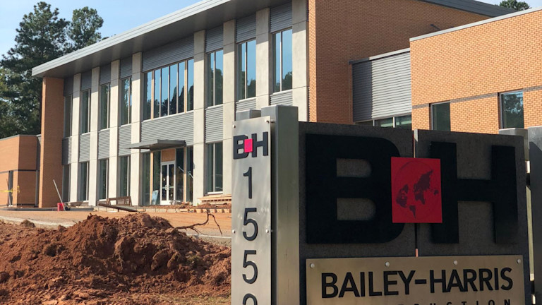 A sign for Bailey Harris Construction Company displayed prominently in front of a building