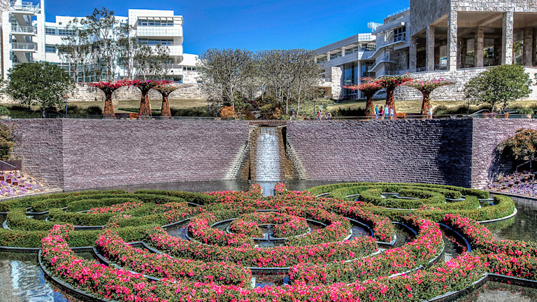 a circular fountain with flowers in it