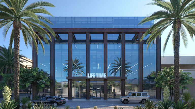 A modern office building with a "Life Time" sign above the entrance