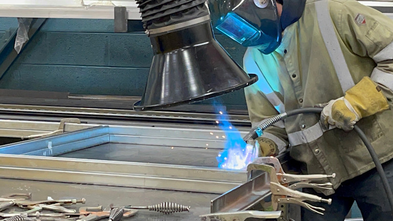 a person welding a piece of metal